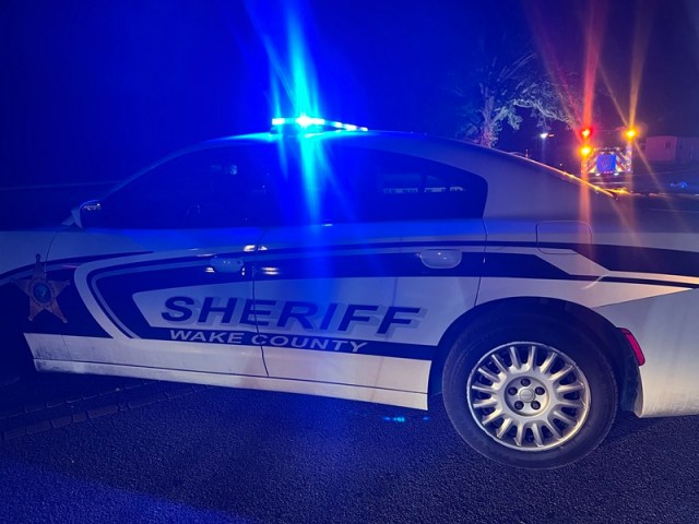 Wake County Sheriff patrol vehicle with emergency lights flashing at night during North Carolina motorcycle pursuit